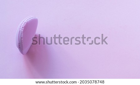 Beauty gadget on pink background.. Facial massager and cleanser device for modern beauty skincare.Large image for banner.Copy space