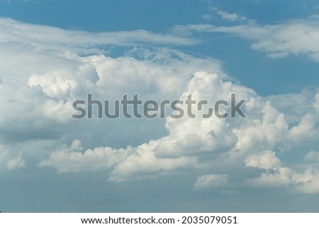 Cumuliform cloudscape on sky. Panorama. The sun is hidden.  Cumulonimbus clouds.