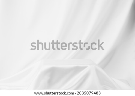 Abstract White Satin Silky Cloth for background, Fabric Textile Drape with Crease Wavy Folds.with soft waves,waving in the wind. Royalty-Free Stock Photo #2035079483