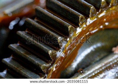 Worn grease can be seen inside the cog wheels unit. This is a partial view of the transmission mechanism from the crank to the chuck of an old hand drill.
 Royalty-Free Stock Photo #2035081115