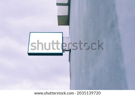 mockup of the advertising box on the wall of the building. Blank frame sign board on a shop wall clean white rectangle signage