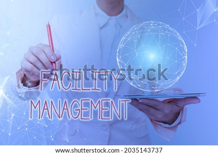 Text caption presenting Facility Management. Conceptual photo maintenance of an organization s is buildings and equipment Woman In Suit Holding Tablet With Circular Holographic Display.