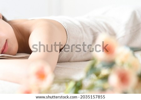 Young woman undergoing esthetic treatment in a massage bed Royalty-Free Stock Photo #2035157855