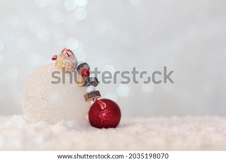Christmas balls on snowy background with copy space