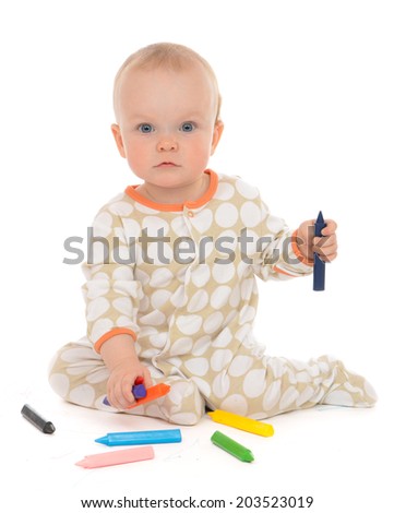 Infant child baby toddler sitting drawing painting with color pencils crayons on a white background