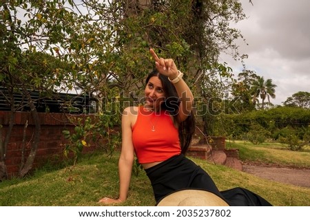 Female model posing in a botanical garden
