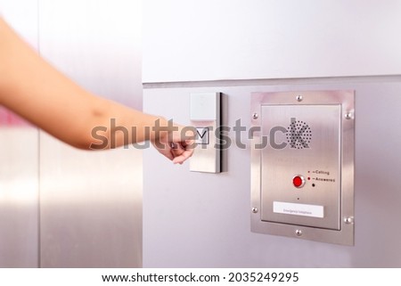 Woman finger pressing the elevator button,Modern lift panel