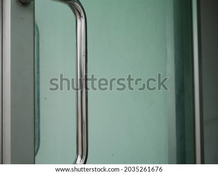 closeup of stainless door handle on the glass door.