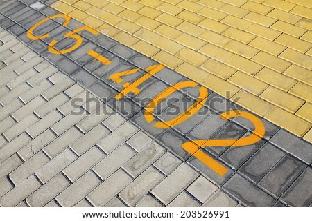 yellow numbers on color cement block, closeup of photo