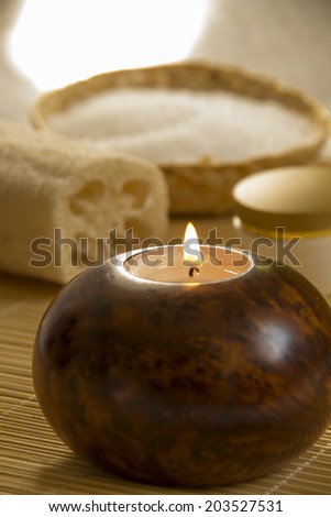 Beautiful spa setting.Loofah,Aromatherapy Candle and Massage cream in a Zen Style Spa 