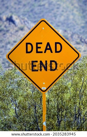 bright yellow "Dead End" road sign with bold black letters, concept for wrong way, no hope, no growth, no development, wrong direction in career and future