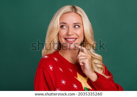 Photo of cheerful happy nice young woman think minded look empty space christmas isolated on green color background