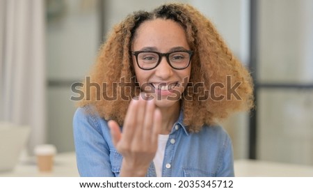 Portrait of African Woman Pointing at the Camera and Inviting 