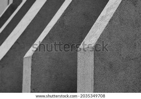 Abstract monochrome architectural geometric composition. Repetitive architectural forms of the exterior of a modern building. Black and white photo Royalty-Free Stock Photo #2035349708