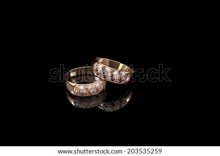 Two  golden rings on black background