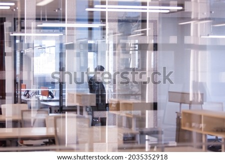 Fashionable office interior, transparent glass partition, reflective reflection and refraction, artistic sense, blurred background