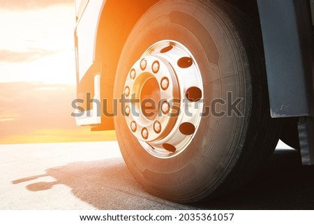 Close up, Front of a Truck Wheels with Sunlight. Rubber Truck Tyres Chrome Wheels. Industry Freight Truck Transportation. Royalty-Free Stock Photo #2035361057