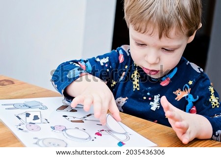 Animals and shapes. baby playing table game. preschool educational aid for kindergartens. children early learning montessori kit for intelligence and development. a glimpse of a concentrated toddler