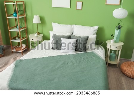 Stylish interior of bedroom with comfortable bed