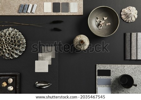 Flat lay of creative architect moodboard composition with samples of building, textile and natural materials and personal accessories. Top view, black backgroung, template. Royalty-Free Stock Photo #2035467545
