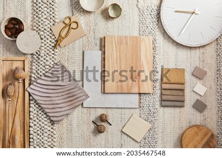 Flat lay of creative architect moodboard composition with samples of building, beige textile and natural materials and personal accessories. Top view, template.