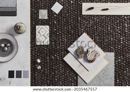 Flat lay of creative architect moodboard composition with samples of building, brown textile and natural materials and personal accessories. Top view, template.