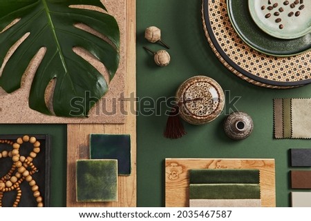 Flat lay of creative architect moodboard composition with samples of building, textile and natural materials and personal accessories. Top view, green background, template.