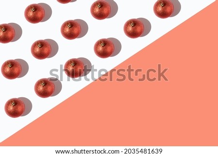 Red sequined Christmas balls pattern on a red and white background. Minimal aesthetic concept. New Year's mood.