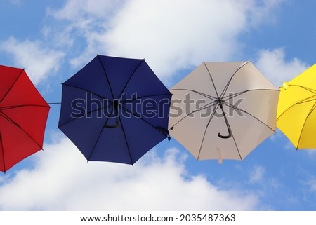 Colorful umbrellas against a blue sky