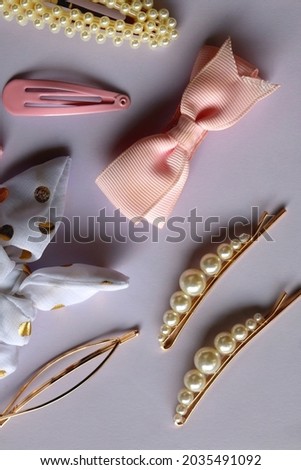 Various hair accessories in pastel and gold tones. Flat lay.