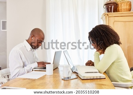 Business man and wife working together on laptop computer at home in the home office Royalty-Free Stock Photo #2035510208