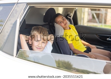 Cute children in car, boy and girl in the car.