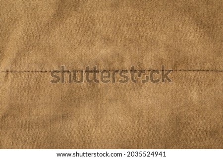 Texture of army rough khaki fabric with seam and dark vignette. Template for design and site header Royalty-Free Stock Photo #2035524941