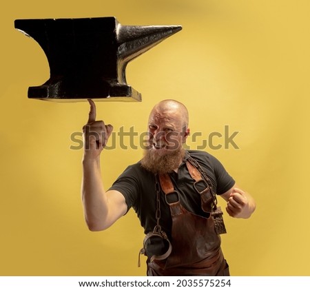 Light touch. Comic image of bearded bald man, blacksmith leather apron or uniform isolated on yellow background. Concept of labor, retro professions, power, beauty, humor. Funny meme emotion