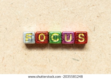 Metallic color alphabet letter block in word focus on wood background