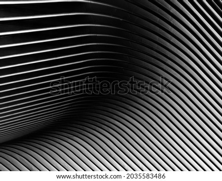 Metallic structure in the shape of waves, in black and white, with fine art processing
