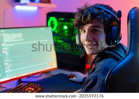 Happy gamer chatting on computer