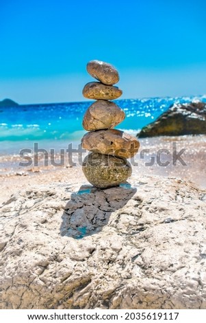 Balanced pebbles on a the beach, close up. Calm and spirit. Stacked stones on the seashore in nature.