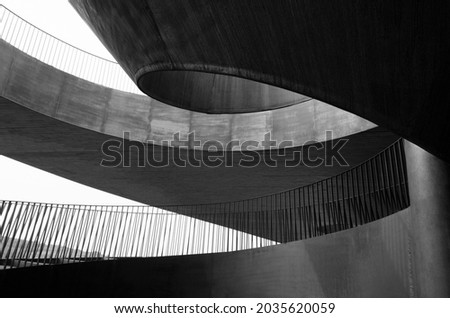 Abstraction of metal stairs, railings and ceilings. Black and white photo Royalty-Free Stock Photo #2035620059