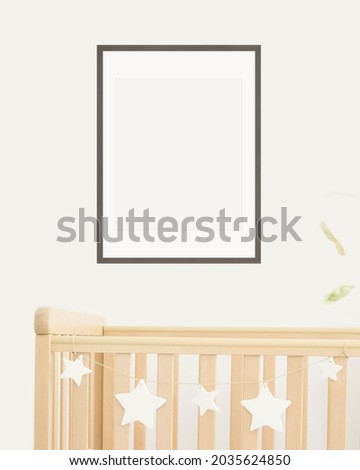 Mock up poster frame in children room, nursery room with wooden crib for kids with white ceramic stars, close-up, white wall, scandinavian style