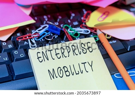 Text caption presenting Enterprise Mobility. Business overview Employees do jobs remotely using a mobile devices Multiple Assorted Collection Office Stationery Photo Placed Over Table