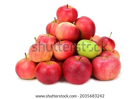 A pile of red and yellow apples. Among them is one green apple. Isolated on white background. Light shadow at the bottom. Royalty-Free Stock Photo #2035683242