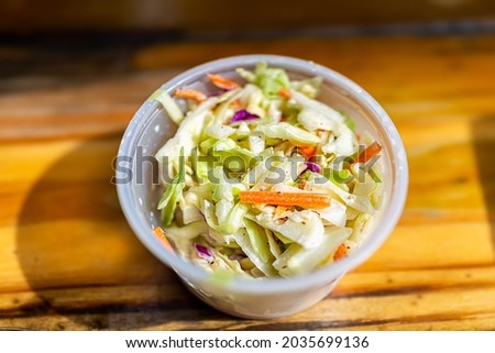 Closeup of shredded cabbage New England cole slaw coleslaw fresh salad with DJ's clam shack with mayonnaise serving in small plastic cup container in Key West, Florida fast food cafe restaurant Royalty-Free Stock Photo #2035699136
