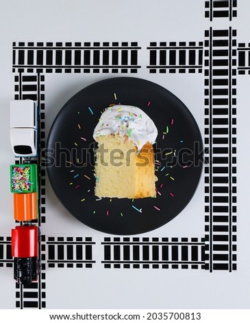 Cupcake on white plate with train and railroad