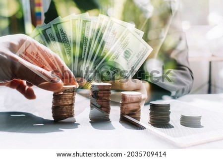 business people working at desk with piggy bank box.business finance saving and investment concept. hand put money coin into piggy bank for saving money wealth.