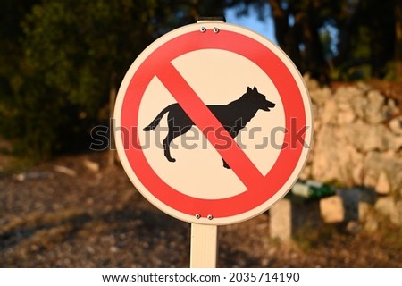 No dogs allowed sign on the beach. Prohibition sign stop dog in park. Animals exclusion zone. Red, black and white symbol. 