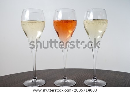 Tasting of white and brut rose champagne sparkling wine from flute glasses Royalty-Free Stock Photo #2035714883