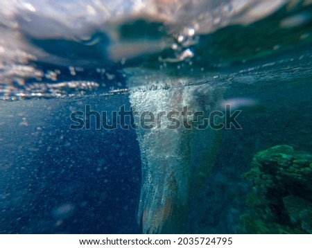Air bubbles in blue water on the background of corals