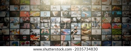 Multimedia video concept on media wall. TV streaming services, video on demand Royalty-Free Stock Photo #2035734830