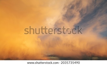 Amazing bright sunset clouds moving over the sky. Beautiful orange and yellow colors gradually fading and the sky clearing in the end.